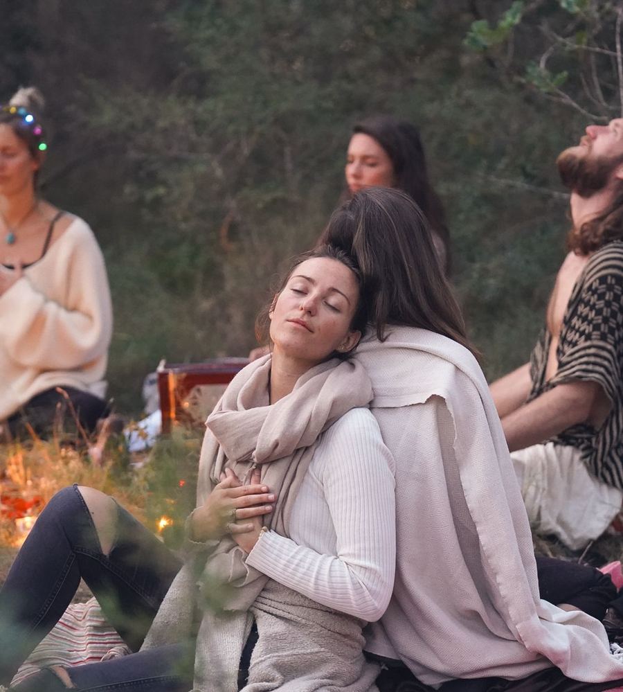 A group of people sitting together in a cacao circle